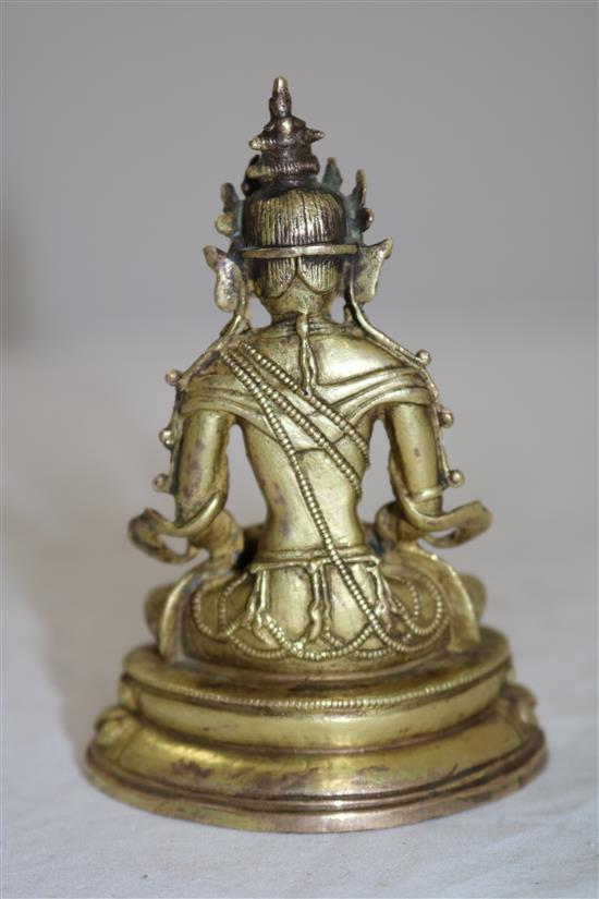 A small Tibetan gilt bronze seated figure of Amitayus, 18th/19th century, height 11cm